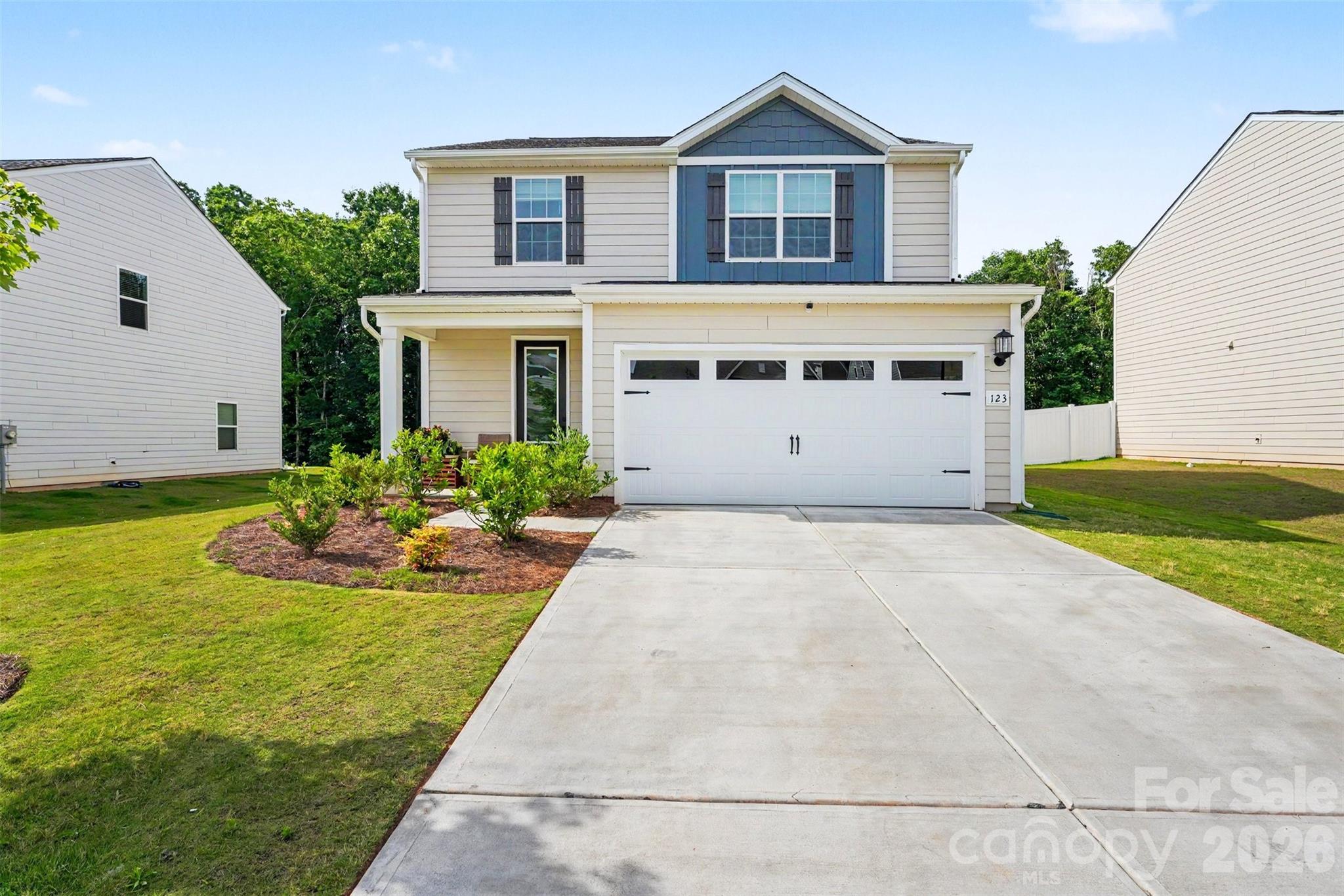 123 Brixham Loop Troutman, NC 28166 - Photo 1 of 18 a view of a house with backyard and garden
