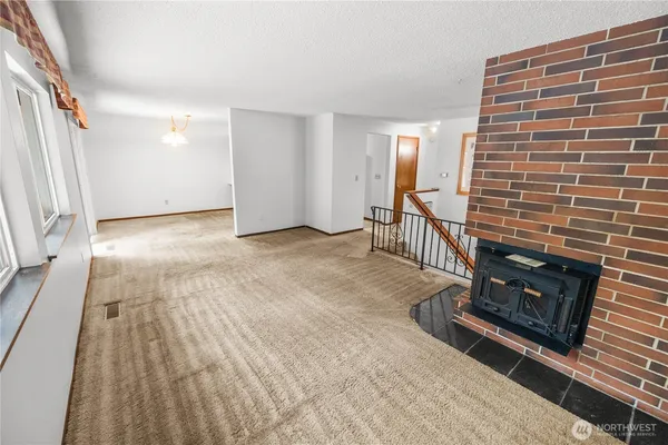 a view of an empty room and fire place