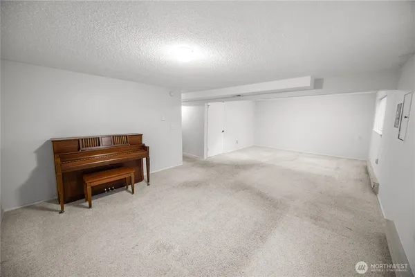a room with a piano and wooden floor