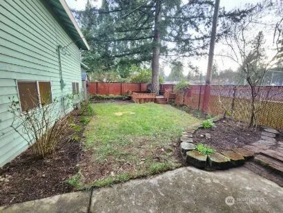a view of backyard with a garden and outdoor seating