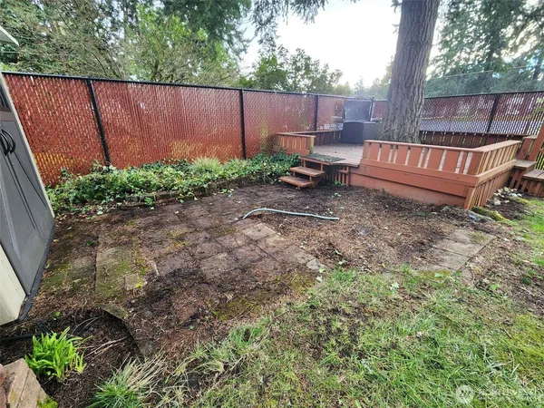 a view of backyard with outdoor seating and green space