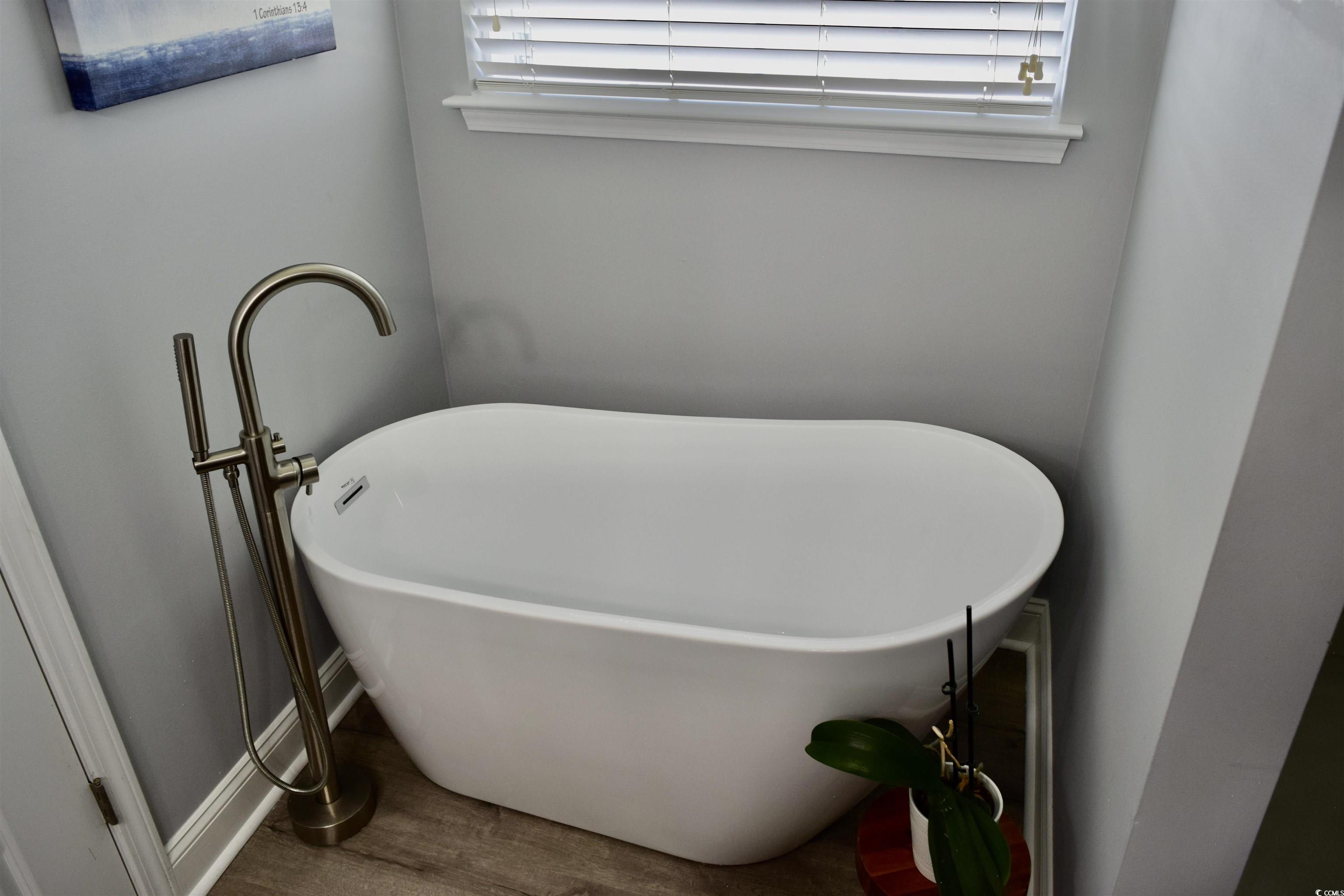 324 Oak Haven Drive Murrells Inlet, SC 29576 - Photo 23 of 38 Bathroom featuring a soaking tub and wood finished floors