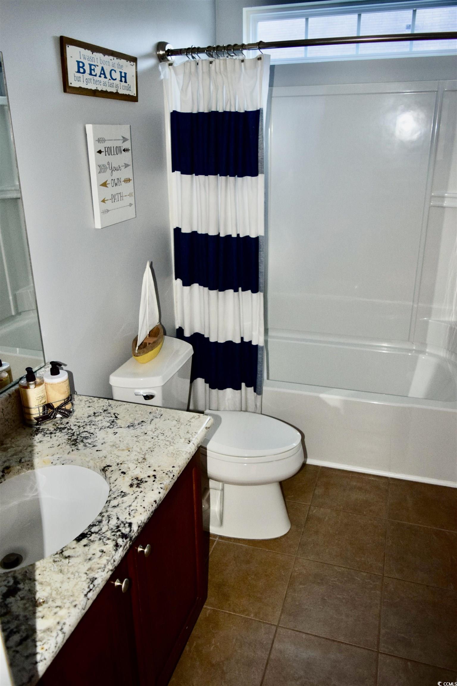 324 Oak Haven Drive Murrells Inlet, SC 29576 - Photo 27 of 38 Bathroom with shower / bathtub combination with curtain, vanity, and dark tile patterned floors