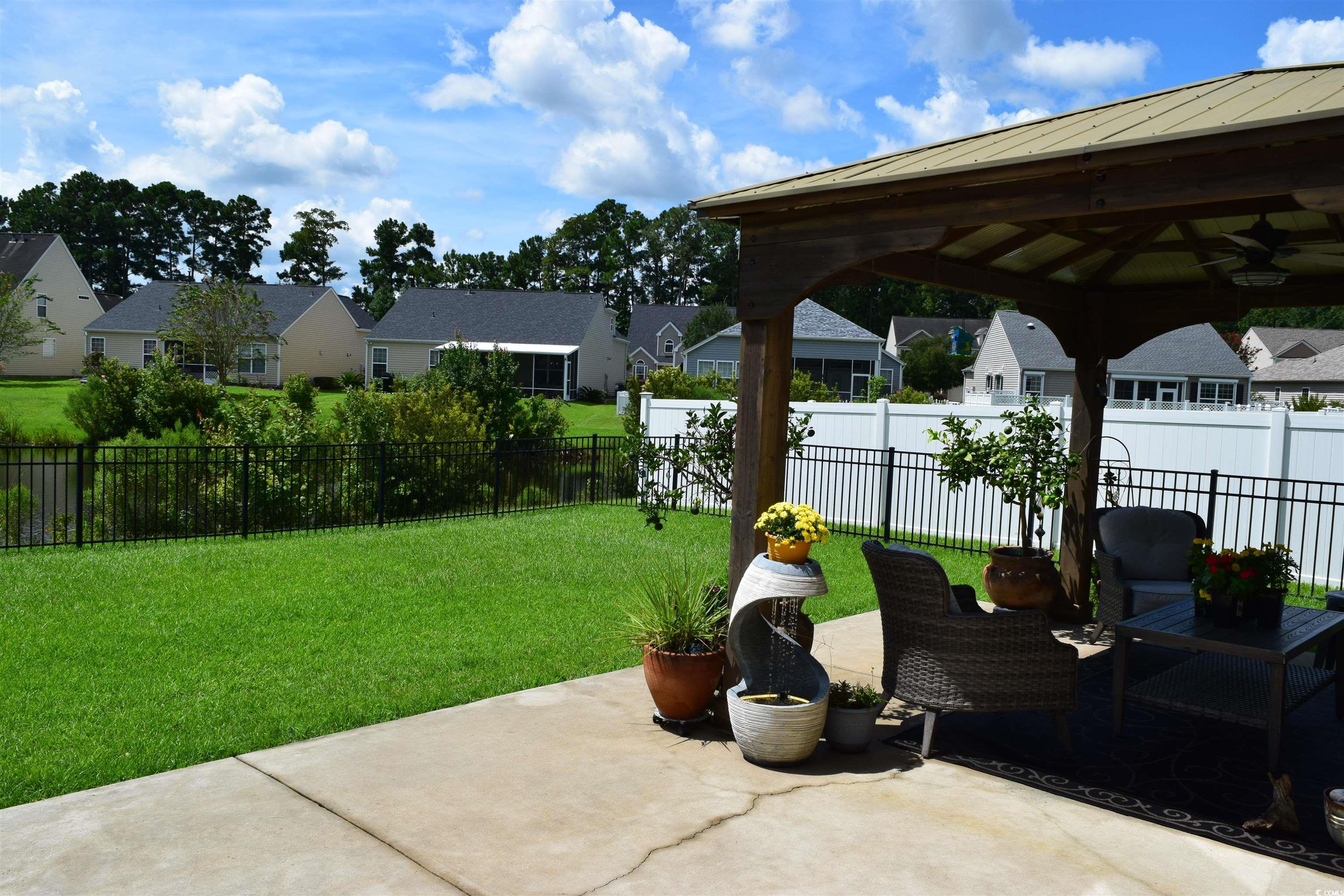324 Oak Haven Drive Murrells Inlet, SC 29576 - Photo 35 of 38 Fenced backyard featuring a residential view, a patio, and a gazebo!