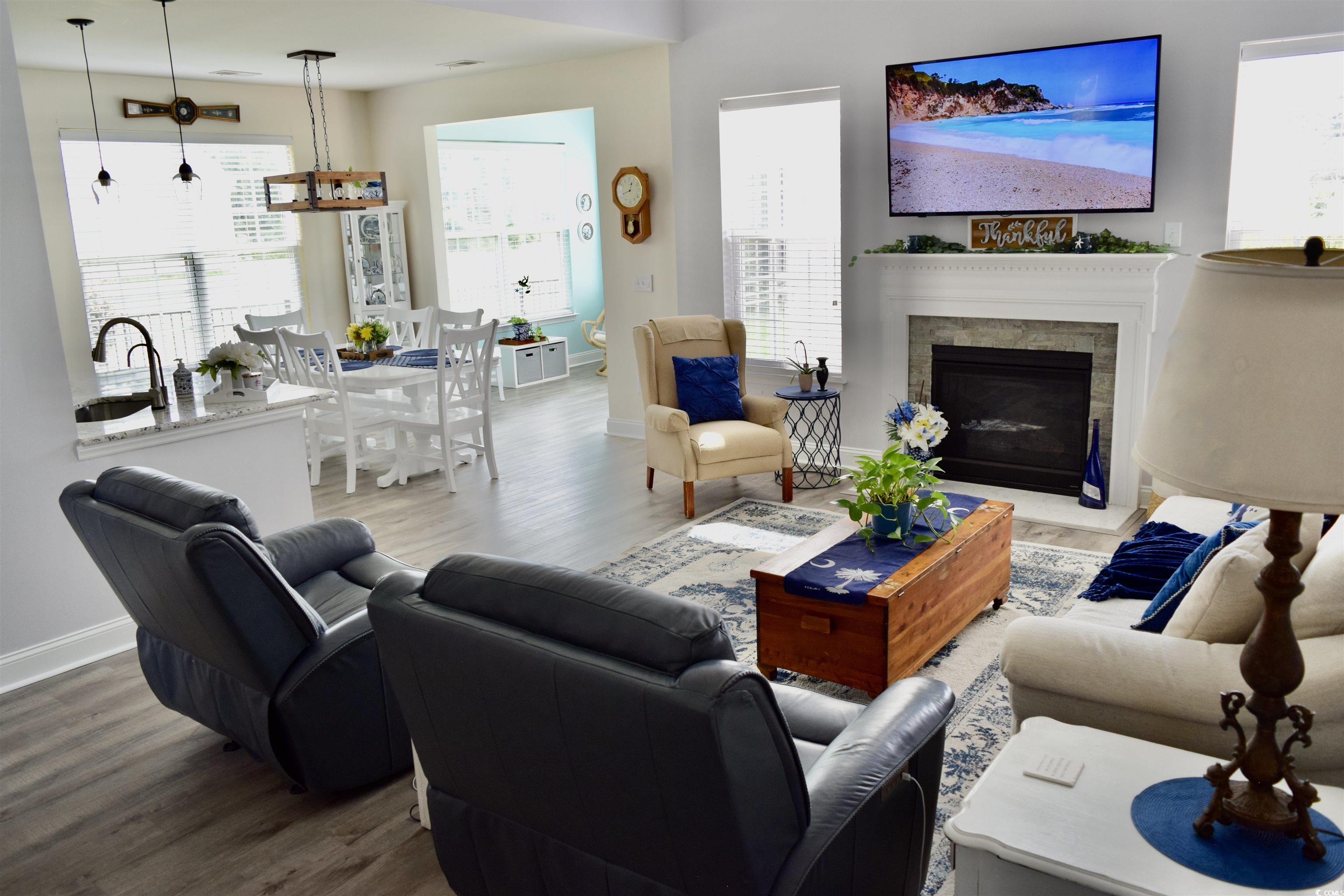 324 Oak Haven Drive Murrells Inlet, SC 29576 - Photo 7 of 38 Living area featuring wood finished floors and a glass covered fireplace