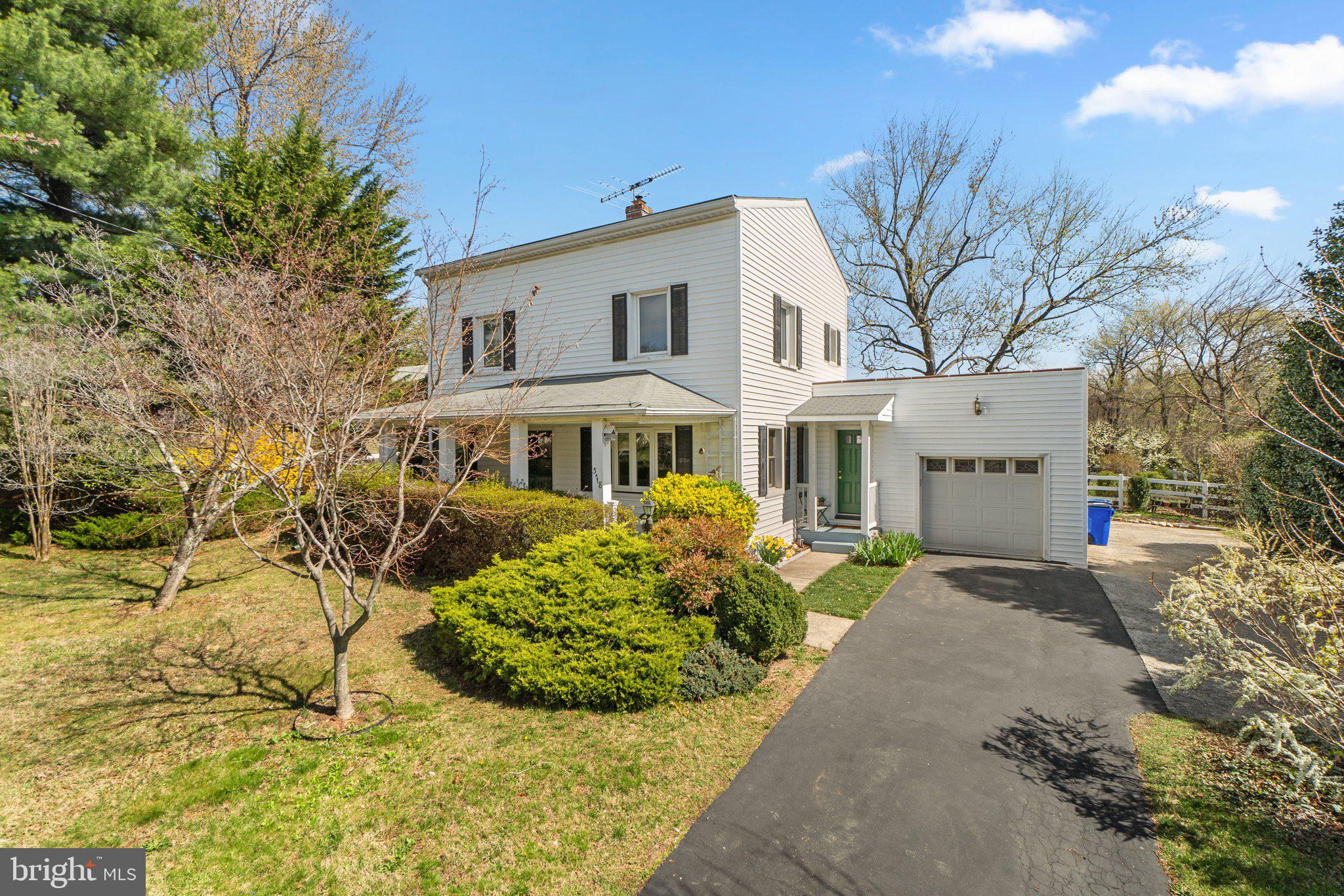 5718 Shookstown Road Frederick, MD 21702 - Photo 1 of 32 a front view of a house with a garden and tree