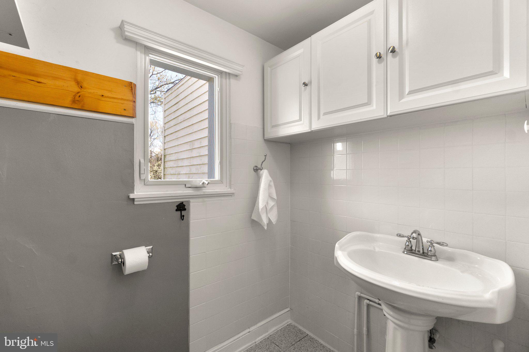 5718 Shookstown Road Frederick, MD 21702 - Photo 12 of 32 a bathroom with a sink a window and a mirror