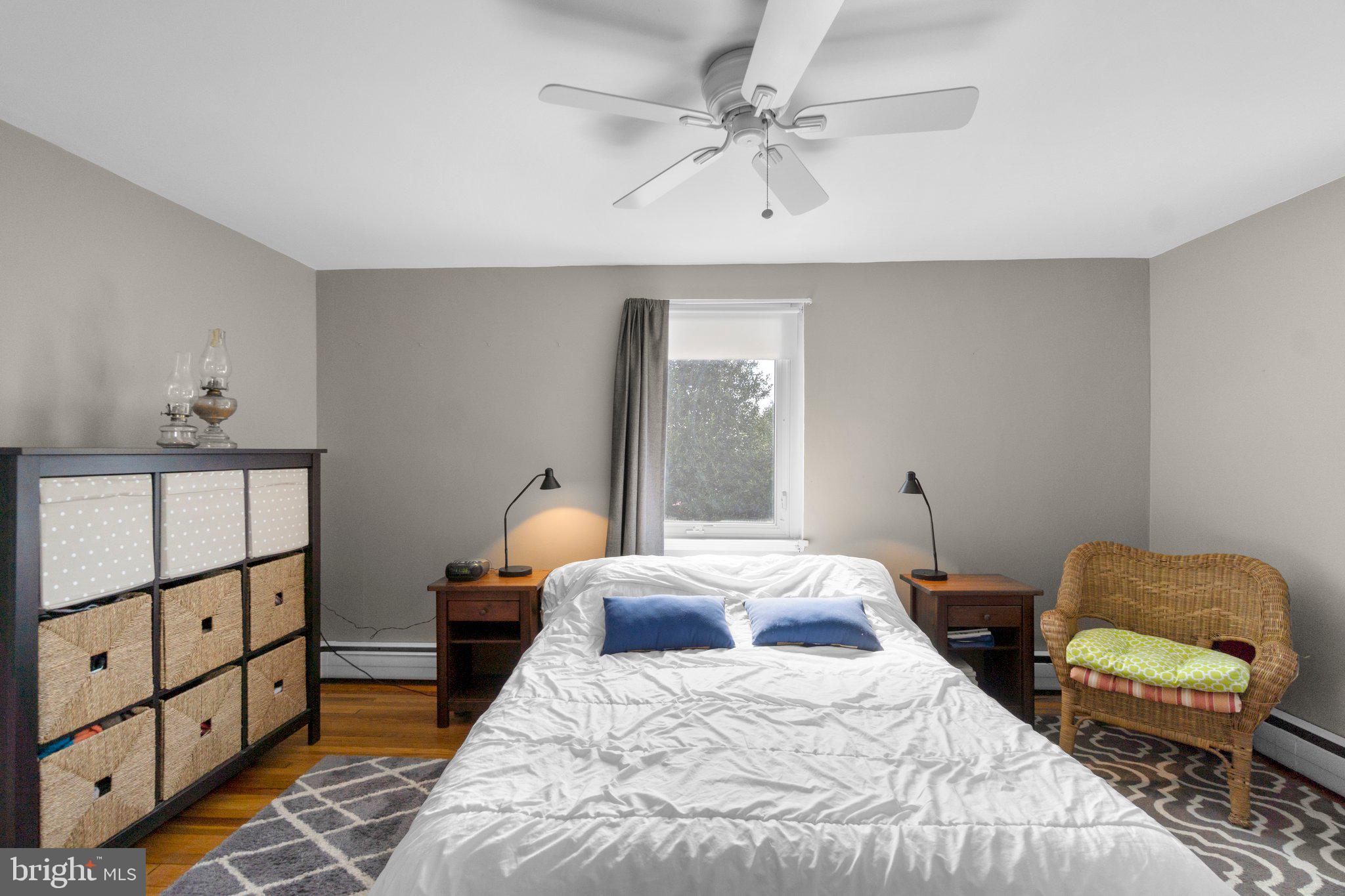 5718 Shookstown Road Frederick, MD 21702 - Photo 13 of 32 a bedroom with a bed and wooden floor
