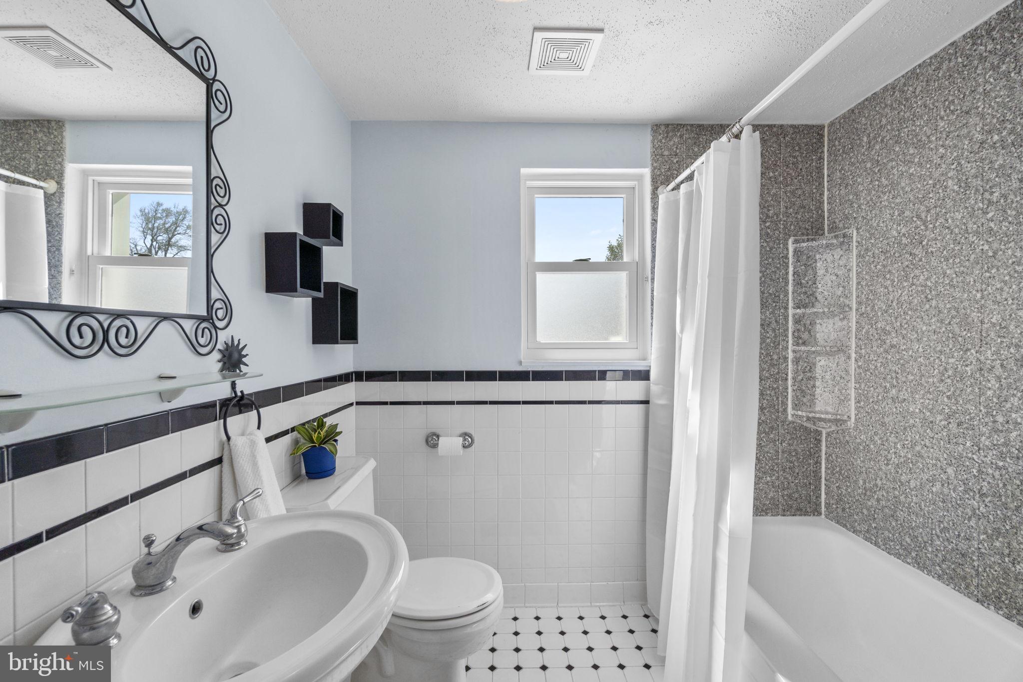 5718 Shookstown Road Frederick, MD 21702 - Photo 15 of 32 a bathroom with a sink toilet a shower and bathtub