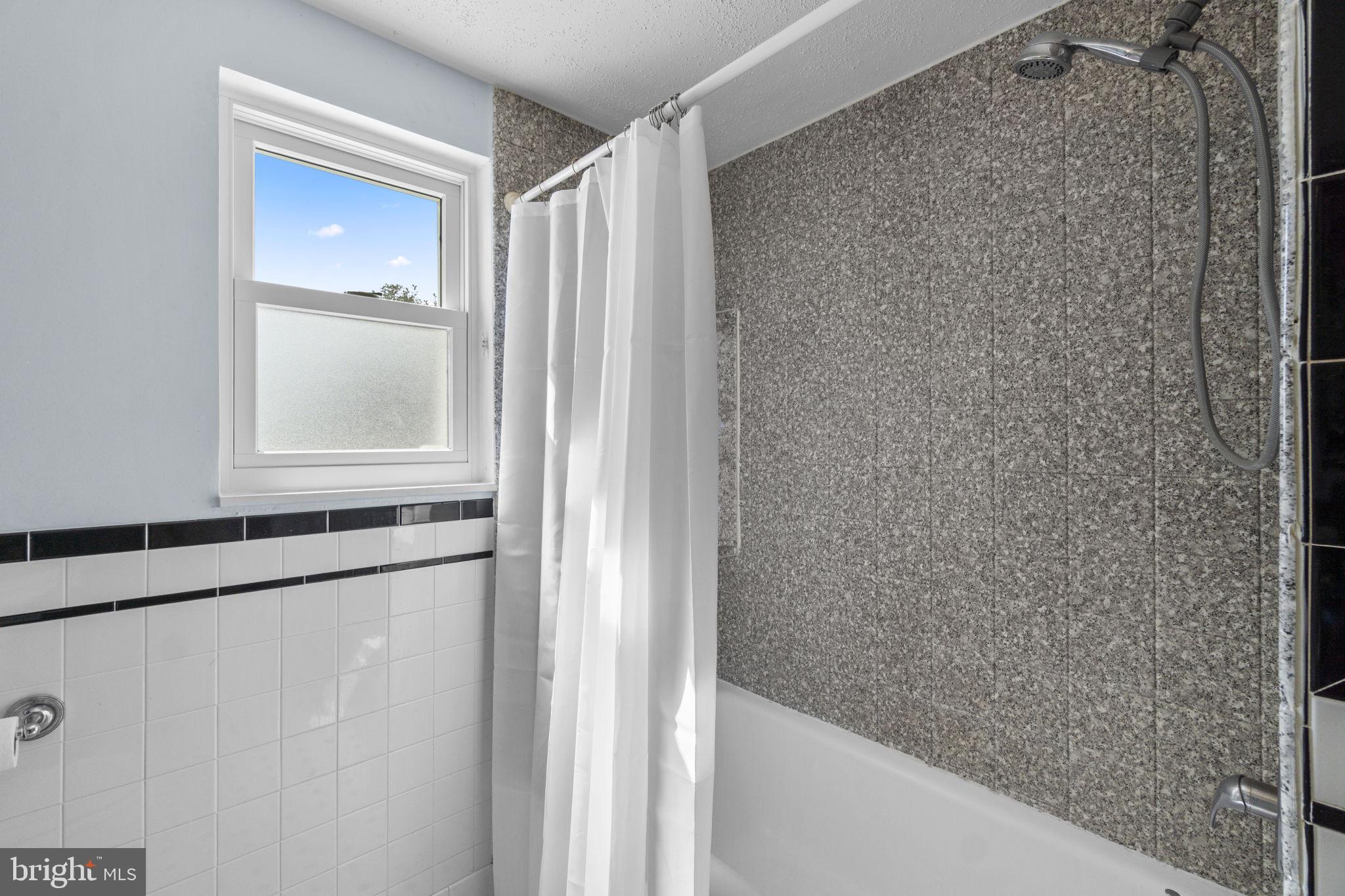 5718 Shookstown Road Frederick, MD 21702 - Photo 17 of 32 a bathroom with a bathtub and a shower