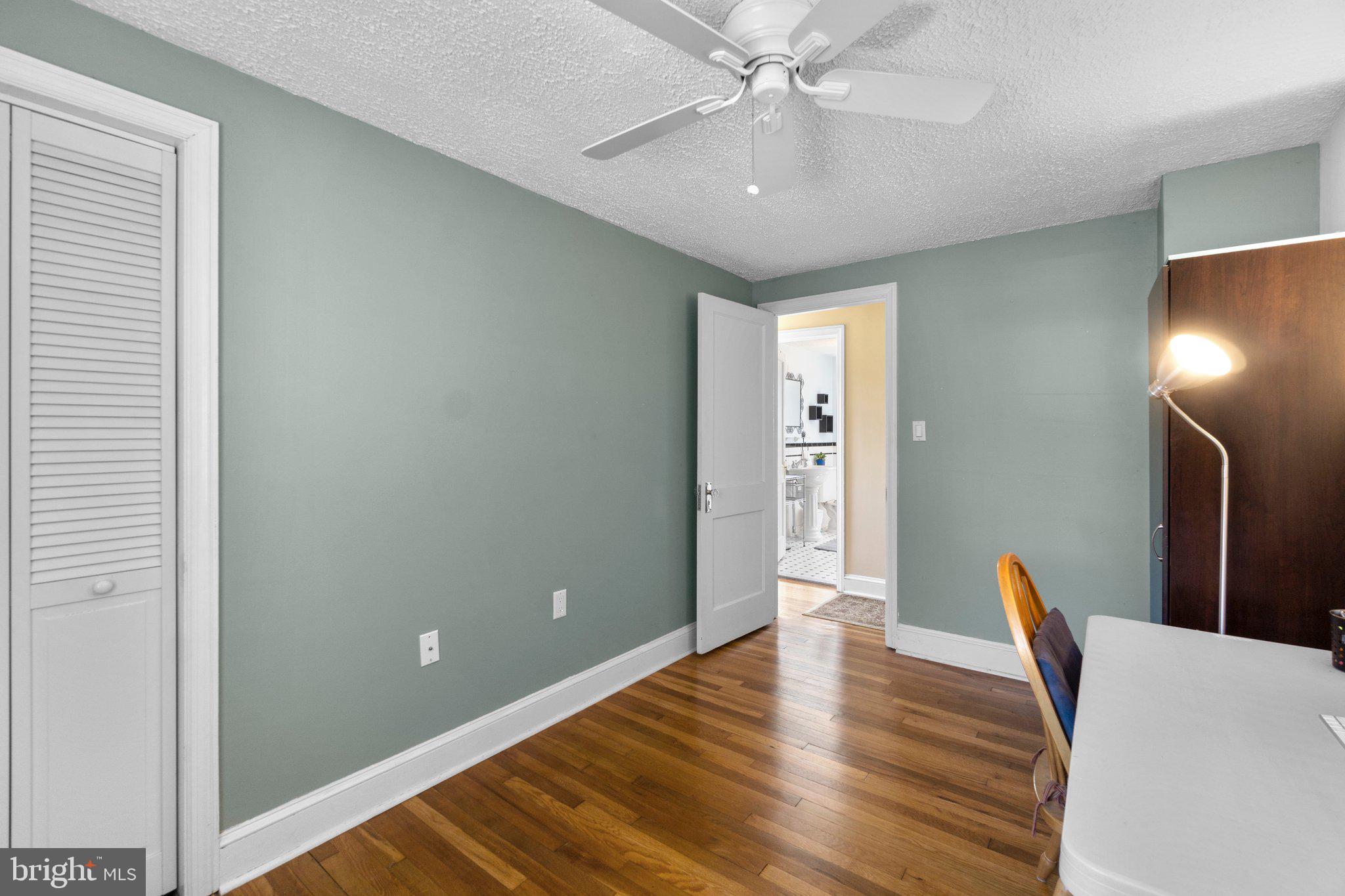 5718 Shookstown Road Frederick, MD 21702 - Photo 18 of 32 a view of an empty room with wooden floor and a ceiling fan