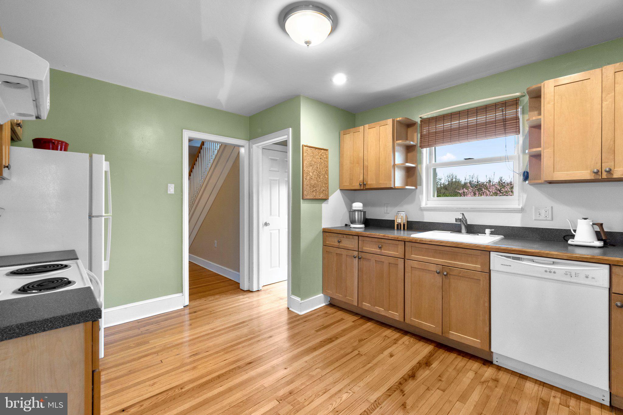 5718 Shookstown Road Frederick, MD 21702 - Photo 9 of 32 a kitchen with stainless steel appliances granite countertop a refrigerator and a sink