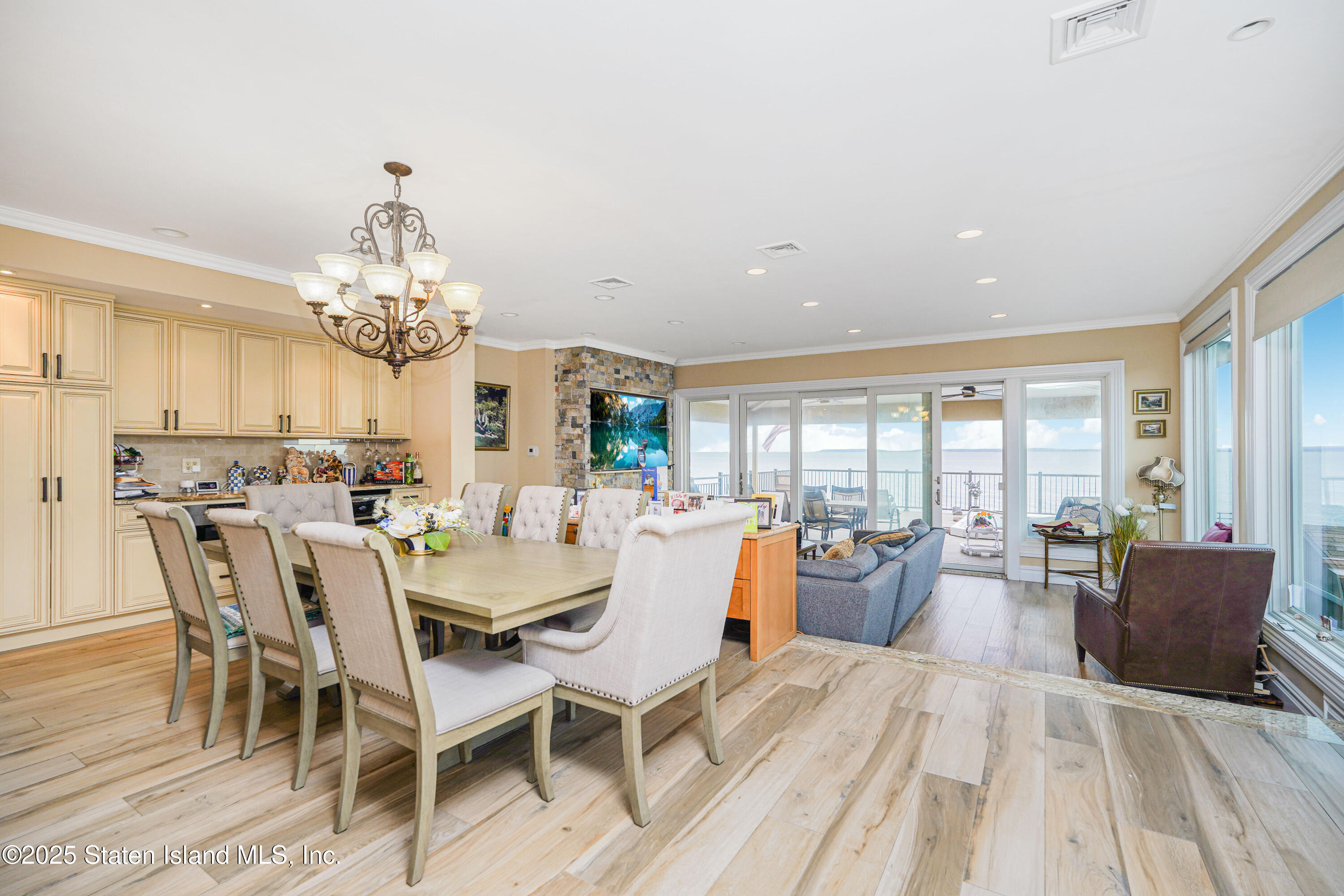 44 Zephyr Avenue Staten Island, NY 10312 - Photo 11 of 54 a view of a dining room with furniture wooden floor and chandelier