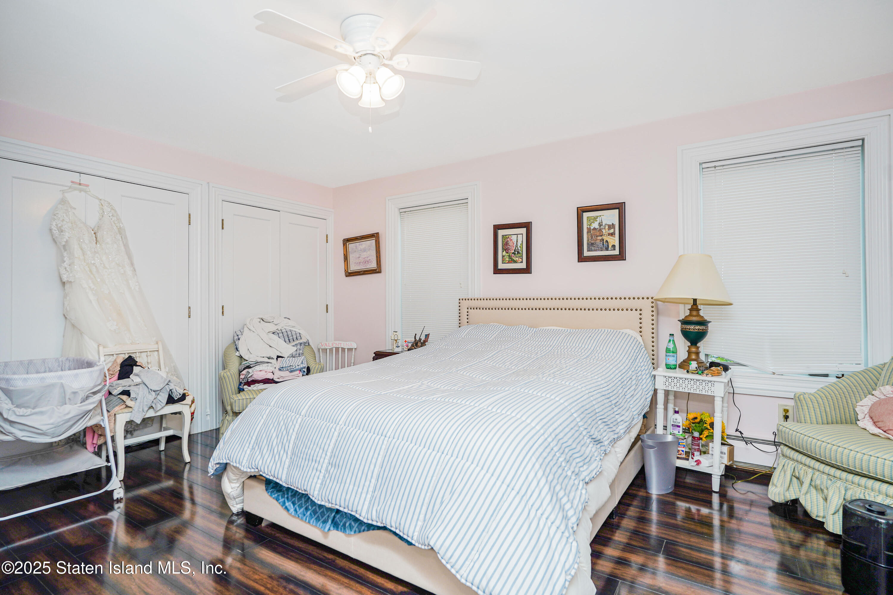 44 Zephyr Avenue Staten Island, NY 10312 - Photo 19 of 54 a bedroom with a bed and a chandelier