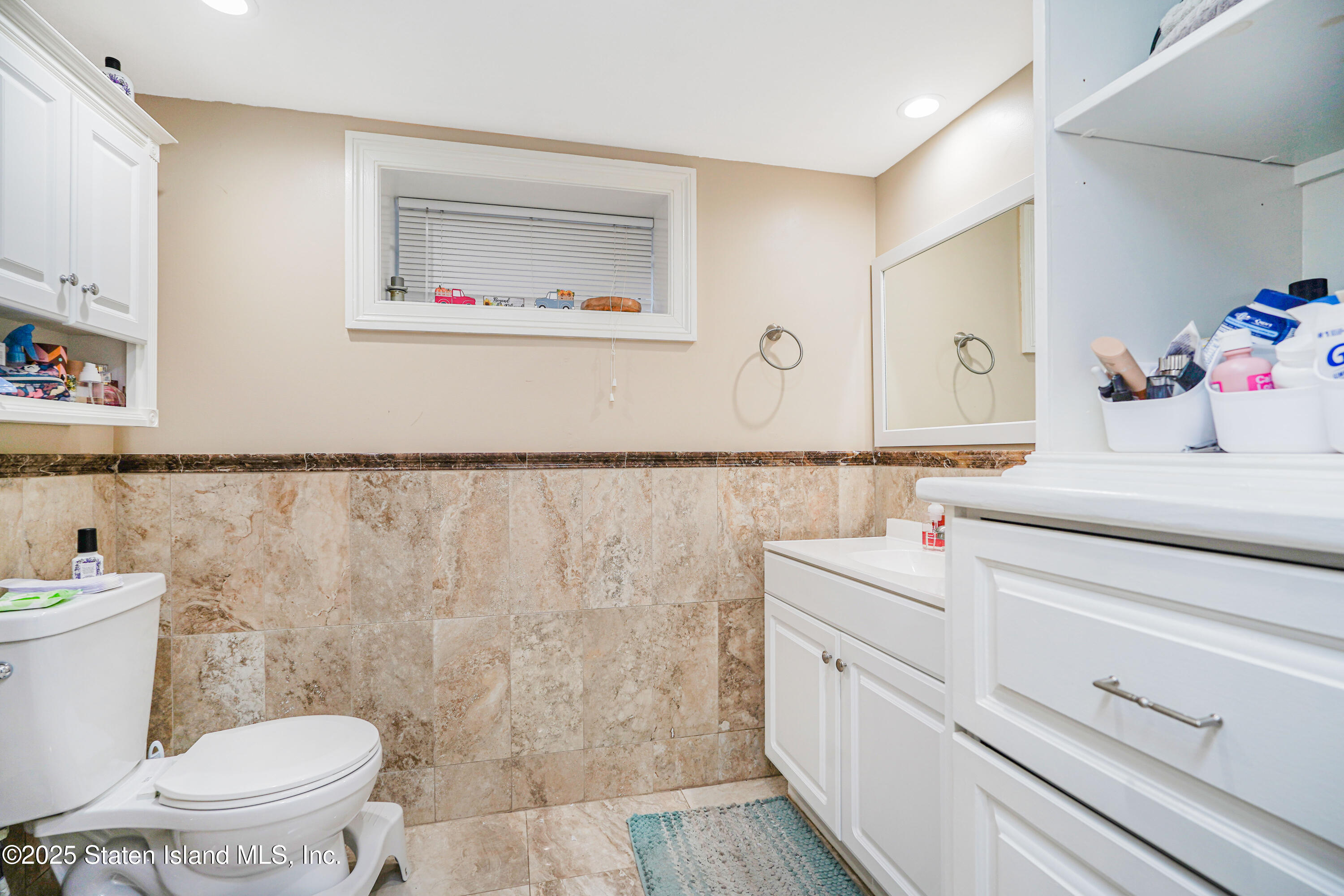 44 Zephyr Avenue Staten Island, NY 10312 - Photo 20 of 54 a bathroom with a sink a toilet and a mirror