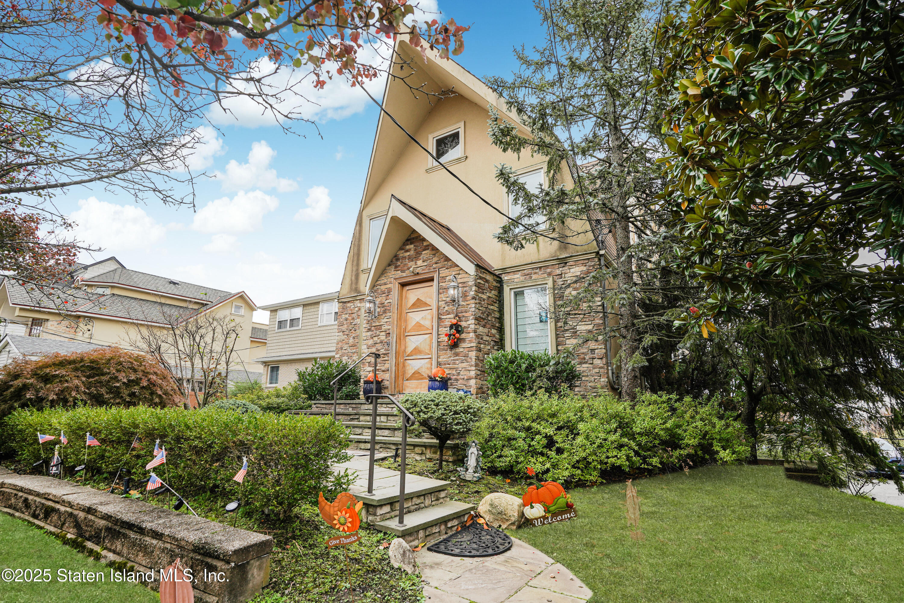 44 Zephyr Avenue Staten Island, NY 10312 - Photo 2 of 54 a front view of a house with a yard and fountain in middle