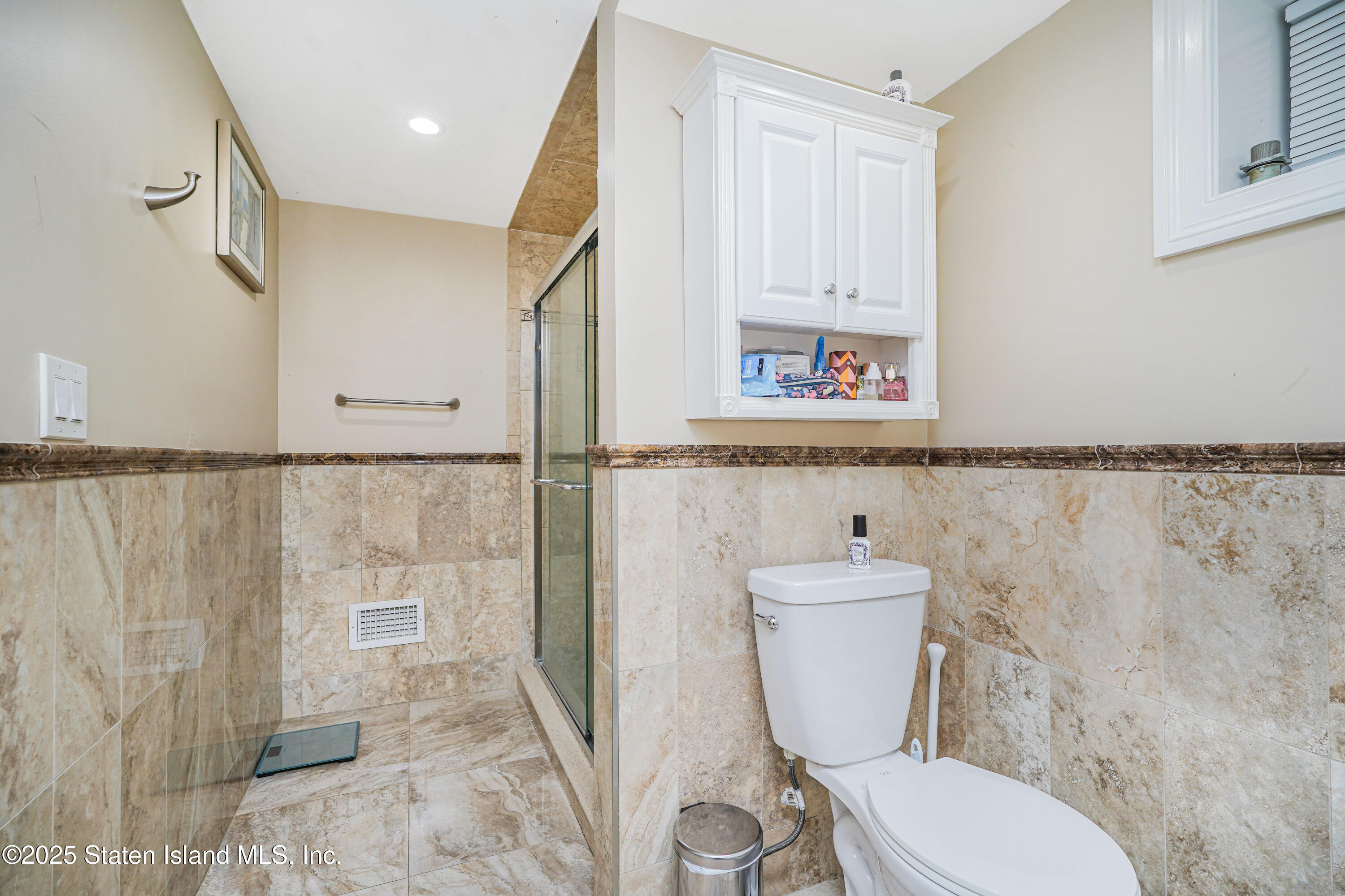 44 Zephyr Avenue Staten Island, NY 10312 - Photo 21 of 54 a white toilet sitting next to a bathroom sink