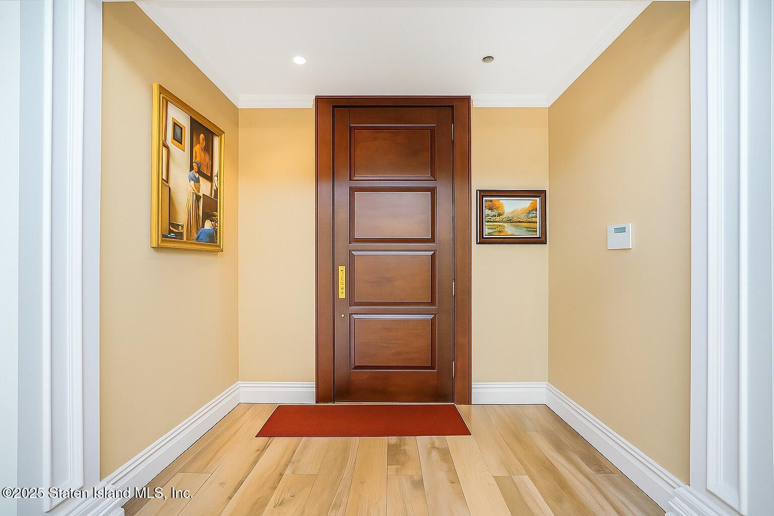 44 Zephyr Avenue Staten Island, NY 10312 - Photo 3 of 54 a view of an empty room with wooden floor and a window