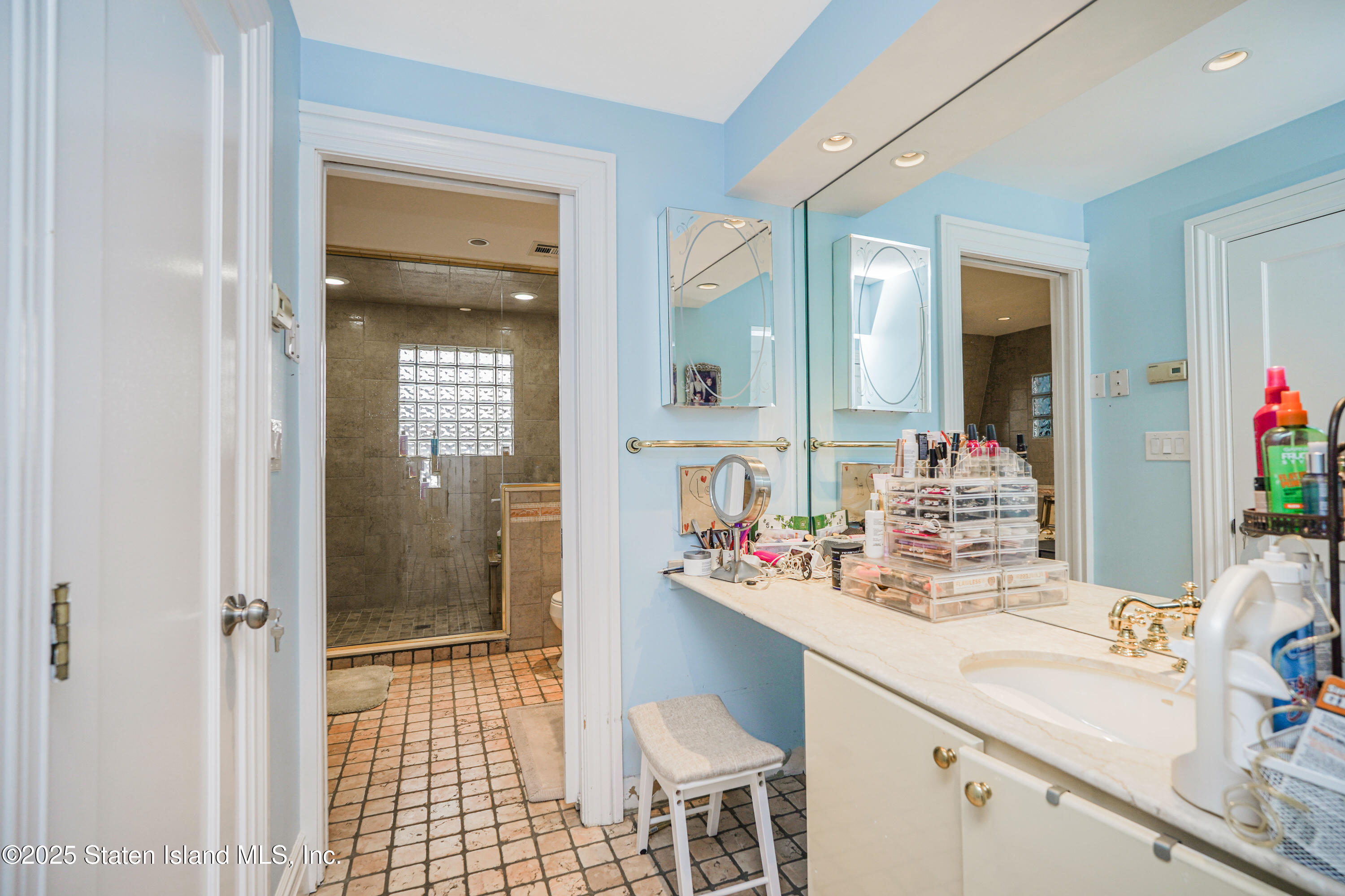 44 Zephyr Avenue Staten Island, NY 10312 - Photo 33 of 54 a bathroom with a sink vanity granite shower and a mirror