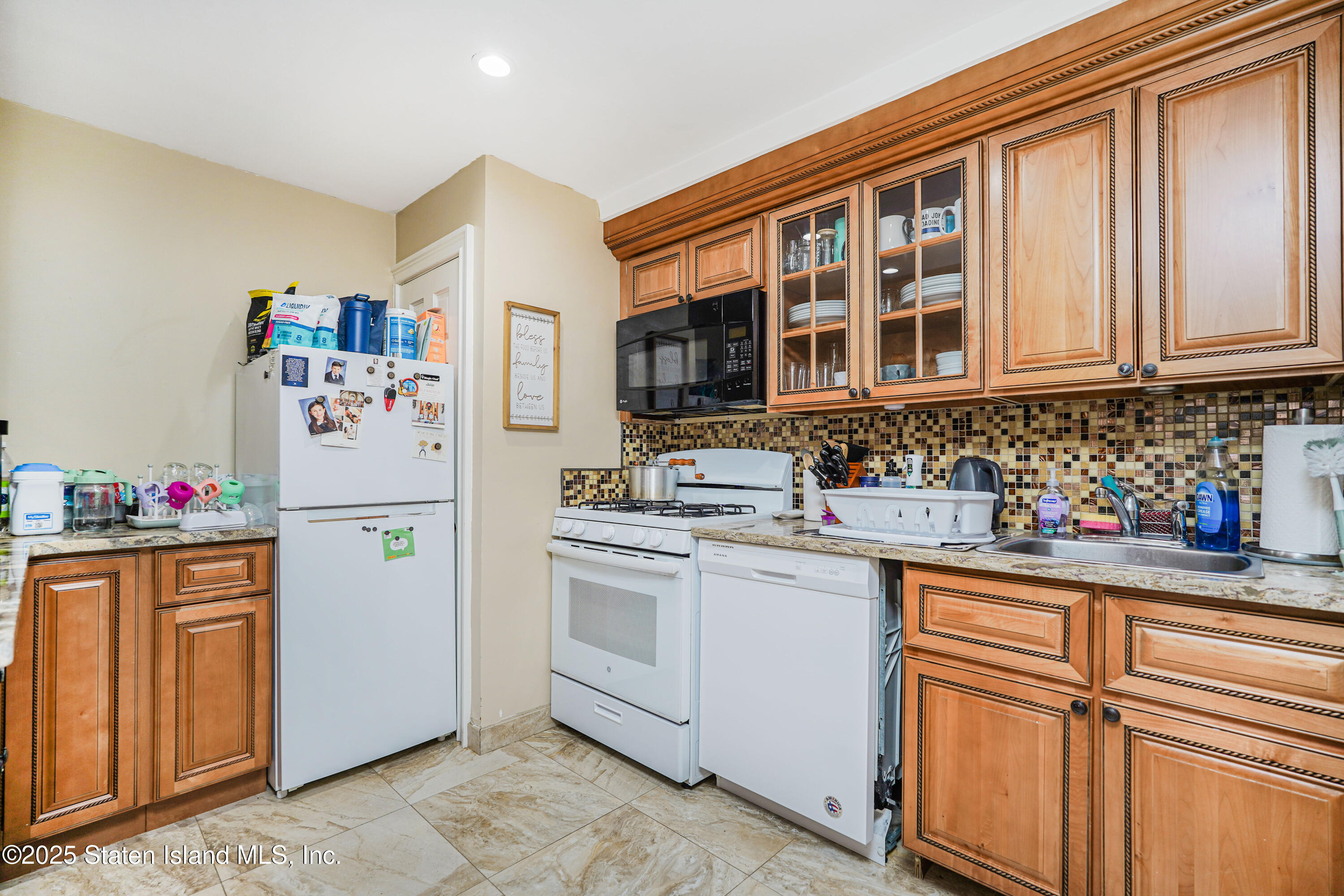 44 Zephyr Avenue Staten Island, NY 10312 - Photo 36 of 54 a kitchen with a refrigerator and cabinets