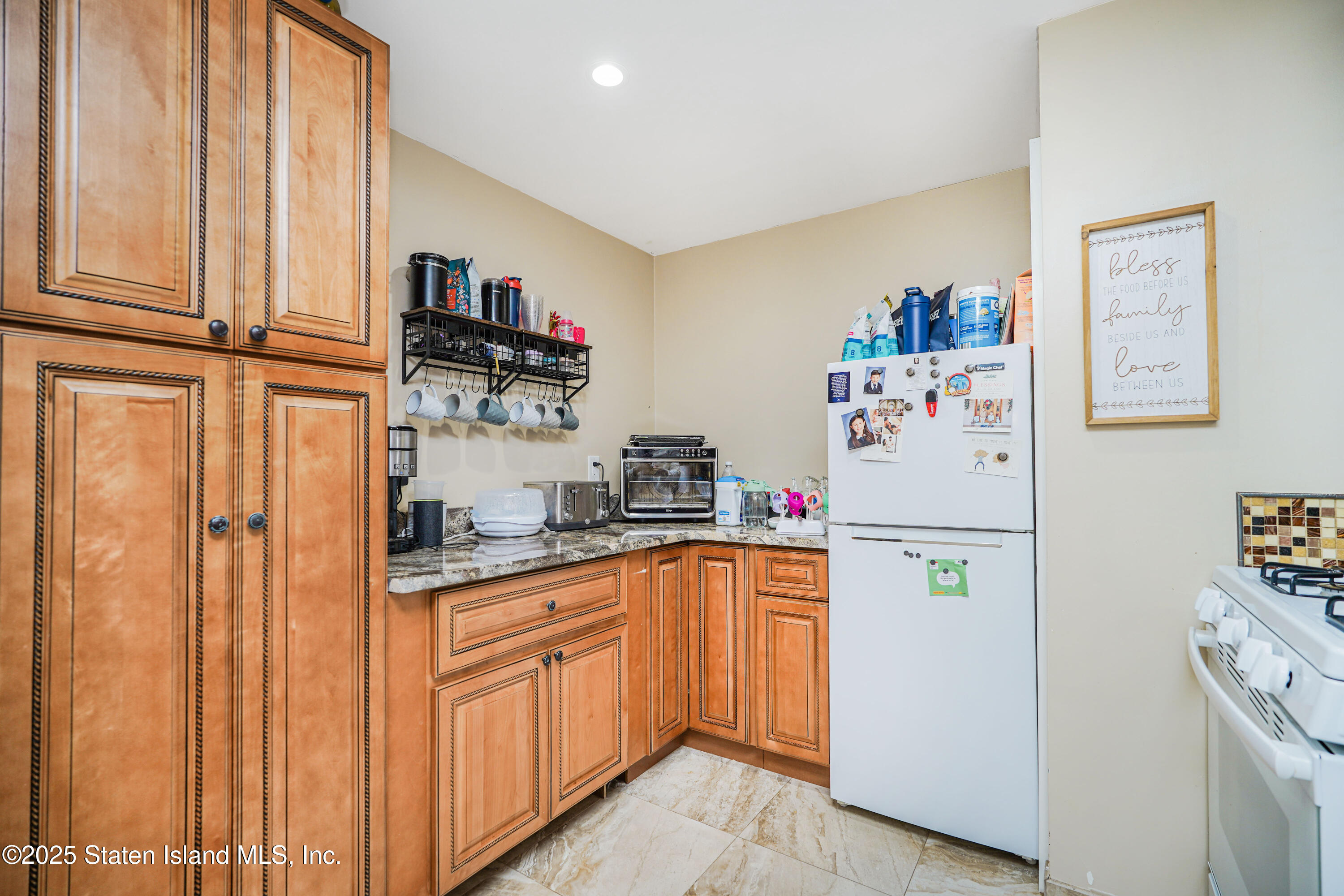 44 Zephyr Avenue Staten Island, NY 10312 - Photo 37 of 54 a white refrigerator freezer sitting inside of a kitchen