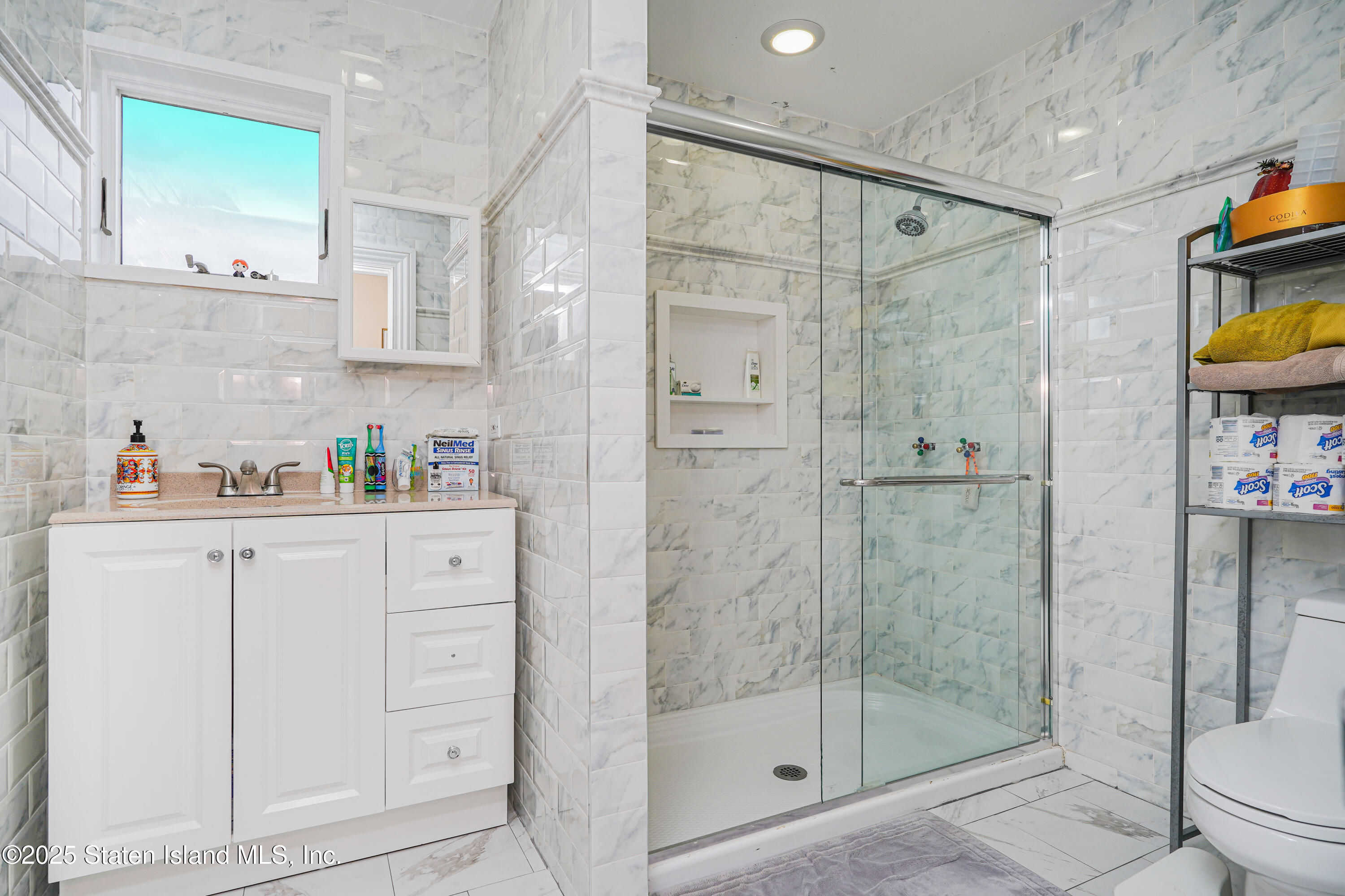 44 Zephyr Avenue Staten Island, NY 10312 - Photo 38 of 54 a bathroom with a shower sink and toilet