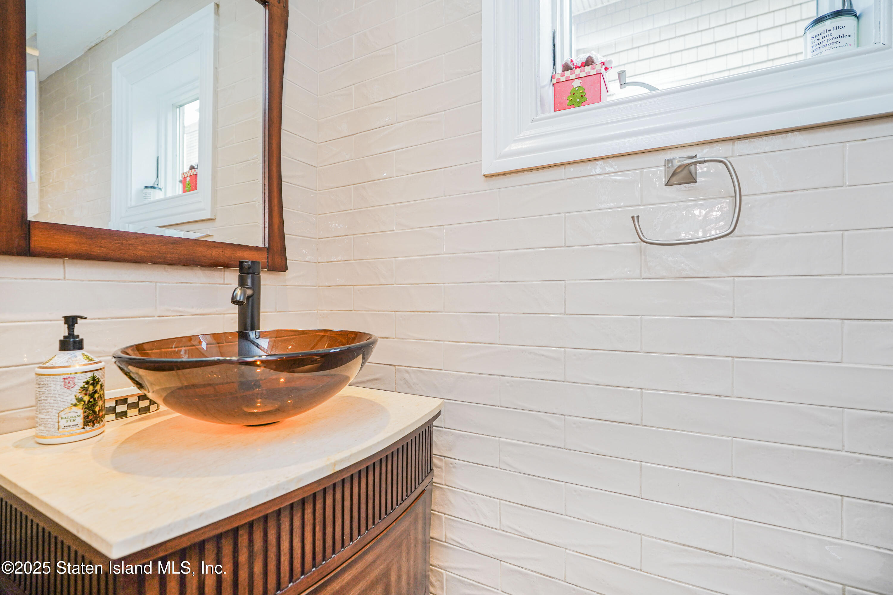 44 Zephyr Avenue Staten Island, NY 10312 - Photo 6 of 54 a bathroom with a sink and a mirror