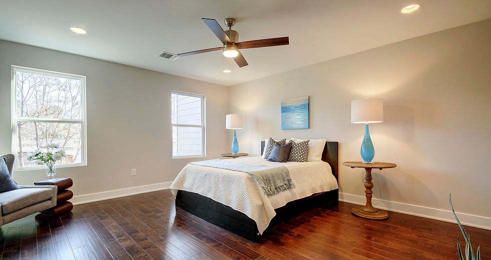 7217 Blessing Avenue, Unit A Austin, TX 78752 - Photo 9 of 22 Large Primary Bedroom with view overlooking lush backyard. Hardwood floors (no carpet ).