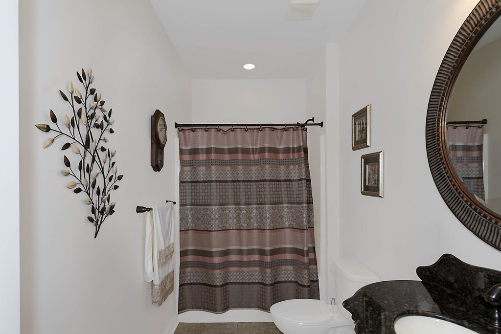 8890 Promenade Place Midland, GA 31820 - Photo 11 of 37 a bathroom with a toilet and a shower curtain