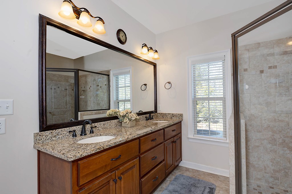 8890 Promenade Place Midland, GA 31820 - Photo 14 of 37 a bathroom with a granite countertop sink and a mirror