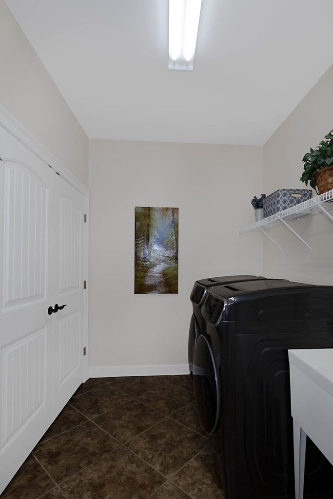8890 Promenade Place Midland, GA 31820 - Photo 15 of 37 a view of walk in closet with clothes and shoes