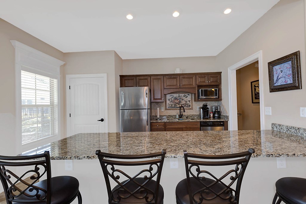8890 Promenade Place Midland, GA 31820 - Photo 28 of 37 a kitchen with stainless steel appliances kitchen island granite countertop a sink and a refrigerator