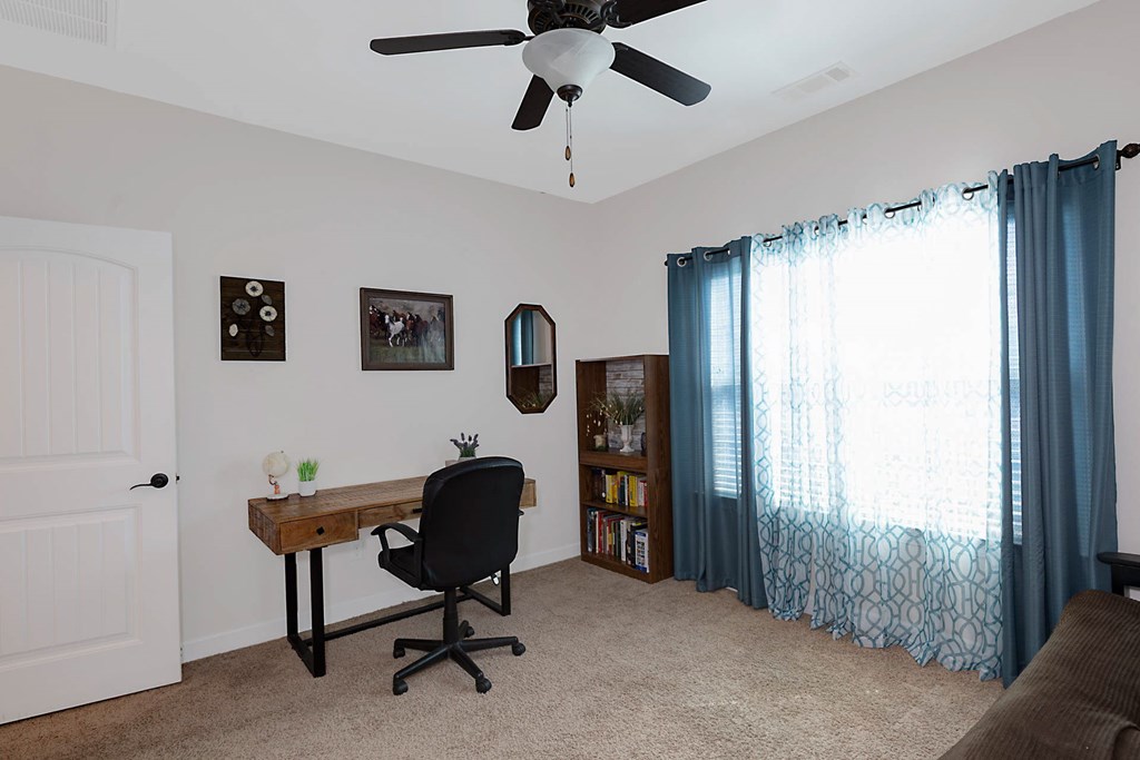 8890 Promenade Place Midland, GA 31820 - Photo 8 of 37 a view of a workspace with furniture and a window