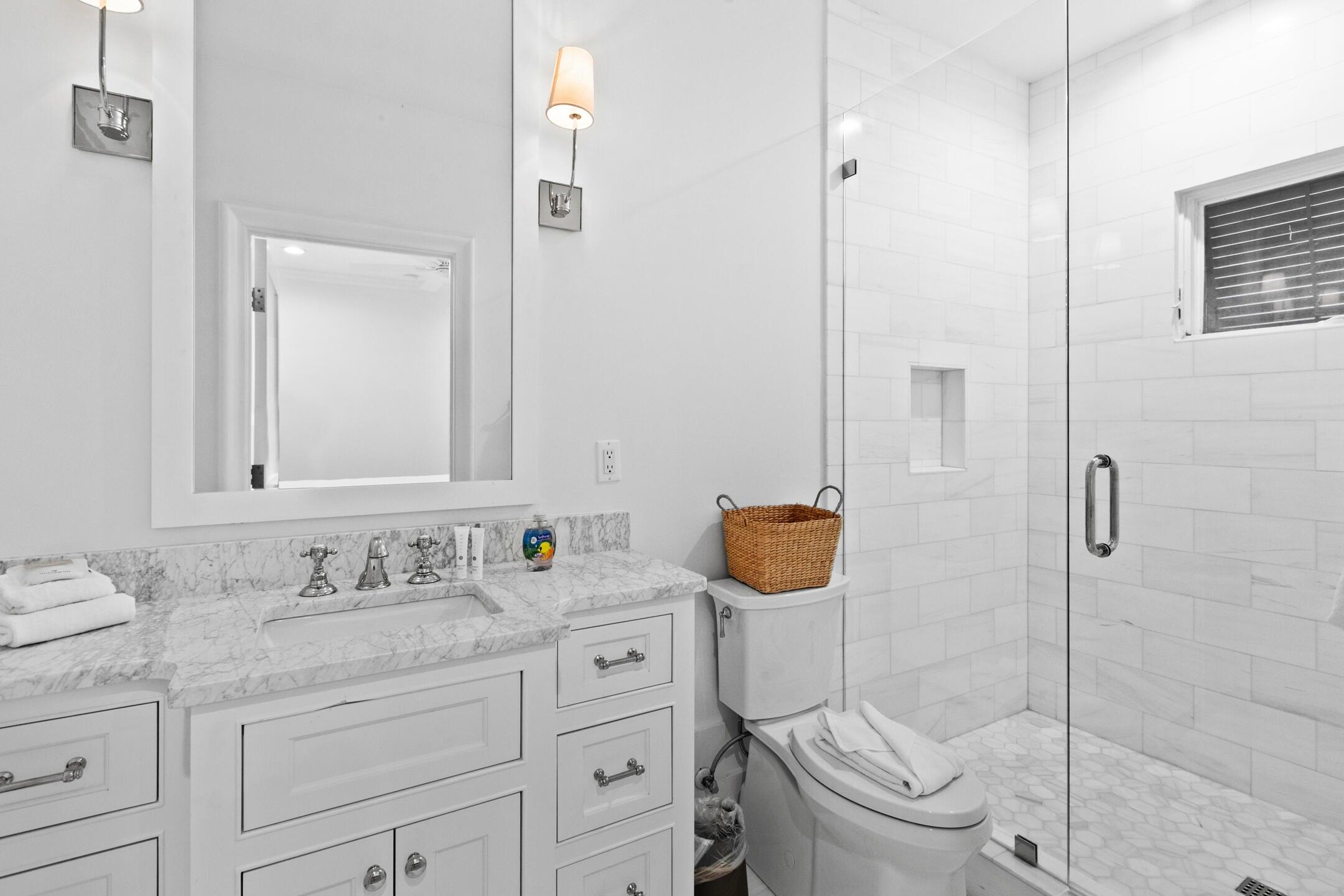 23 Johnstown Lane Inlet Beach, FL 32461 - Photo 6 of 35 a bathroom with a granite countertop sink mirror vanity and toilet