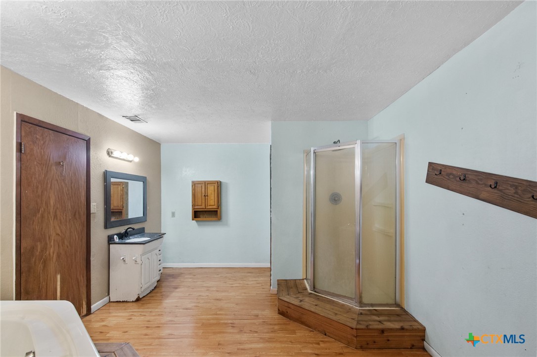 1720 Lower Mission Valley Road Victoria, TX 77905 - Photo 15 of 30 a view of a refrigerator in kitchen and wooden floor