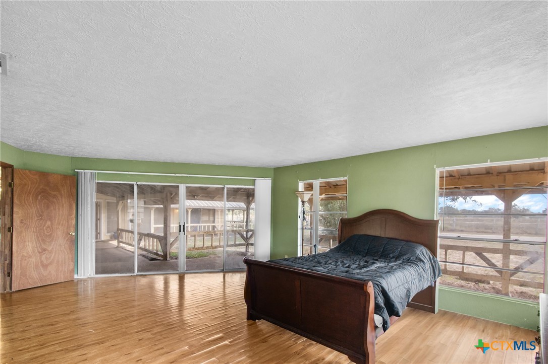 1720 Lower Mission Valley Road Victoria, TX 77905 - Photo 17 of 30 a spacious bedroom with a bed and wooden floor