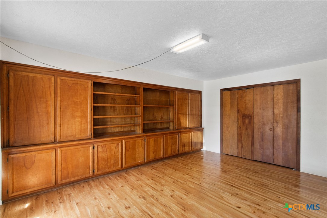 1720 Lower Mission Valley Road Victoria, TX 77905 - Photo 19 of 30 a view of an empty room with wooden floor and a window