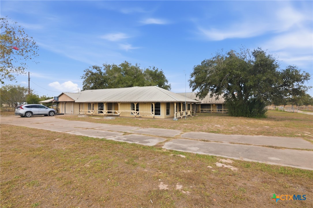 1720 Lower Mission Valley Road Victoria, TX 77905 - Photo 27 of 30 a view of a large white house with a big yard and large trees