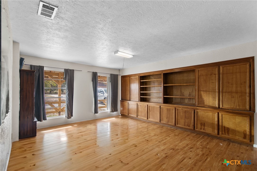 1720 Lower Mission Valley Road Victoria, TX 77905 - Photo 6 of 30 wooden floor in an empty room with a window