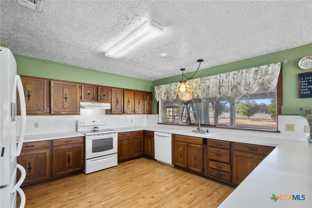 1720 Lower Mission Valley Road Victoria, TX 77905 - Photo 7 of 30 a kitchen with stainless steel appliances granite countertop a stove top oven sink and cabinets