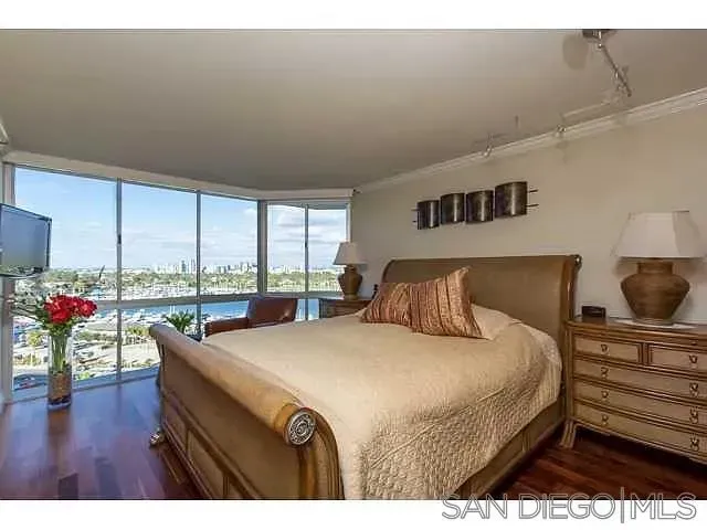 a bedroom with a large bed and a window