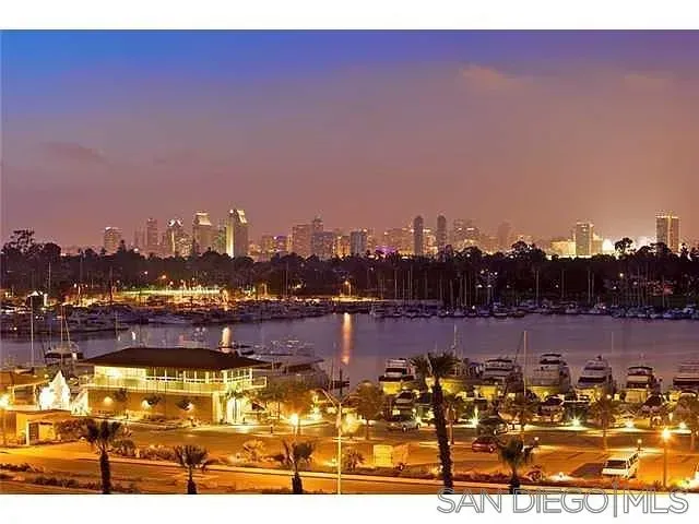 a bathroom with a granite countertop sink mirror and toilet