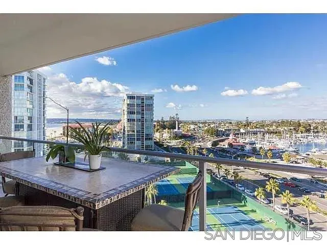 a dining room with furniture and a floor to ceiling window