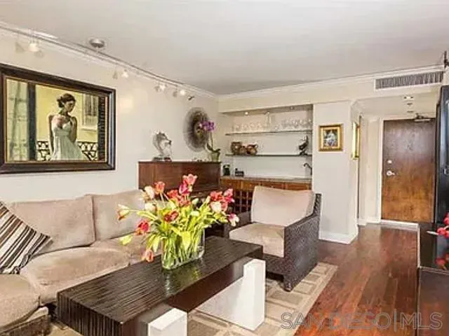 a living room with furniture flowerpot and a chandelier