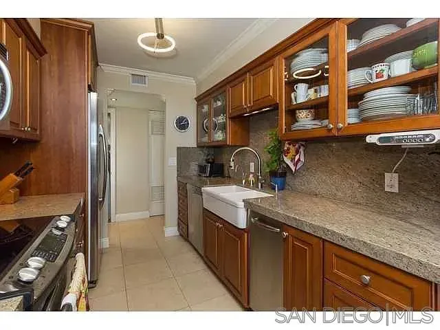 a kitchen with stainless steel appliances granite countertop a sink stove and cabinets