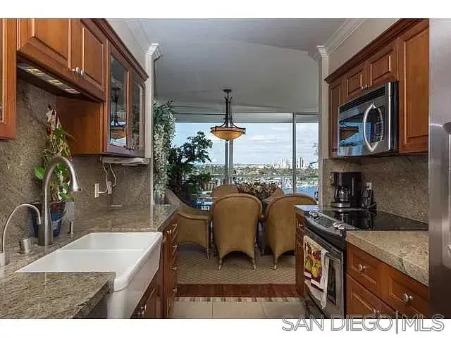 a kitchen has a stove a refrigerator and a sink