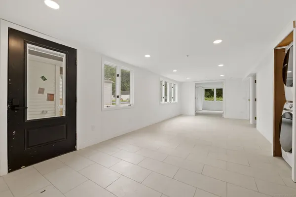 a view of a hallway with closet and bathroom