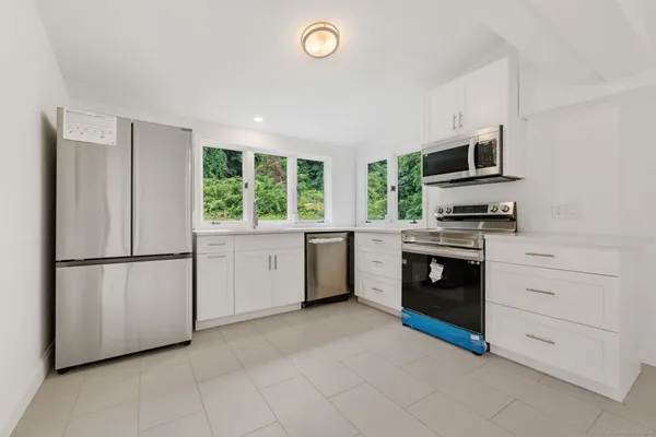 a kitchen with a stove sink and a refrigerator