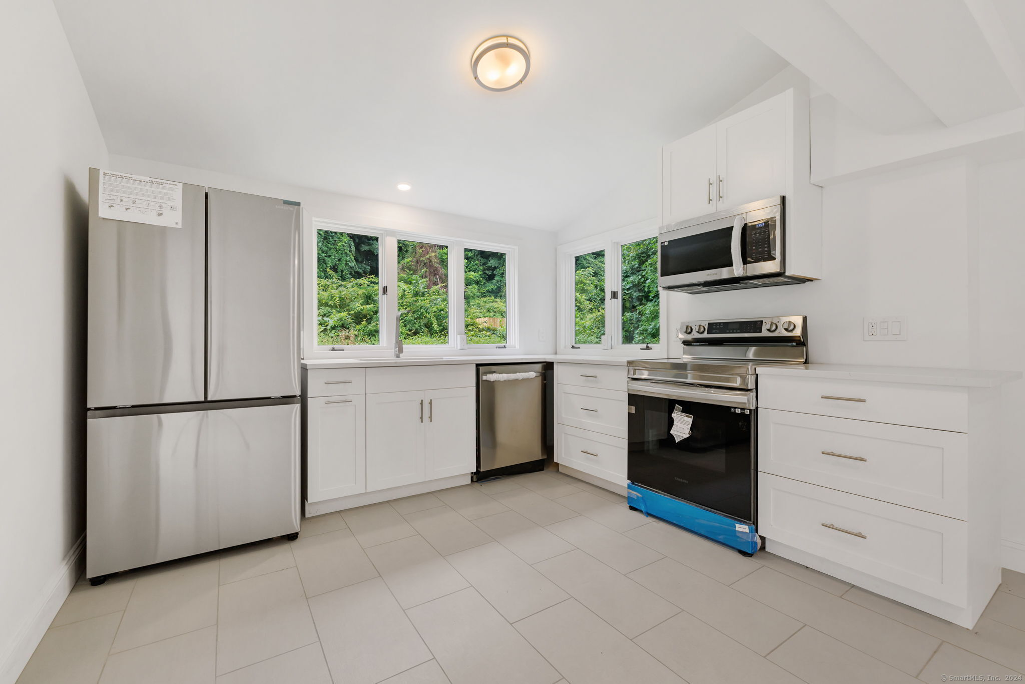 529 Danbury Road, Unit A Wilton, CT 06897 - Photo 15 of 23 a kitchen with a stove sink and a refrigerator