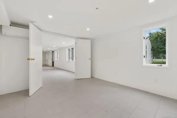 a view of a big room with windows and entryway